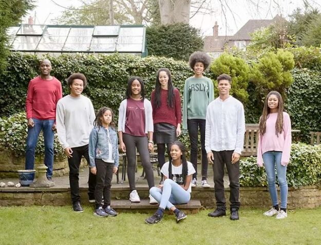 family photograph with two parents and seven siblings